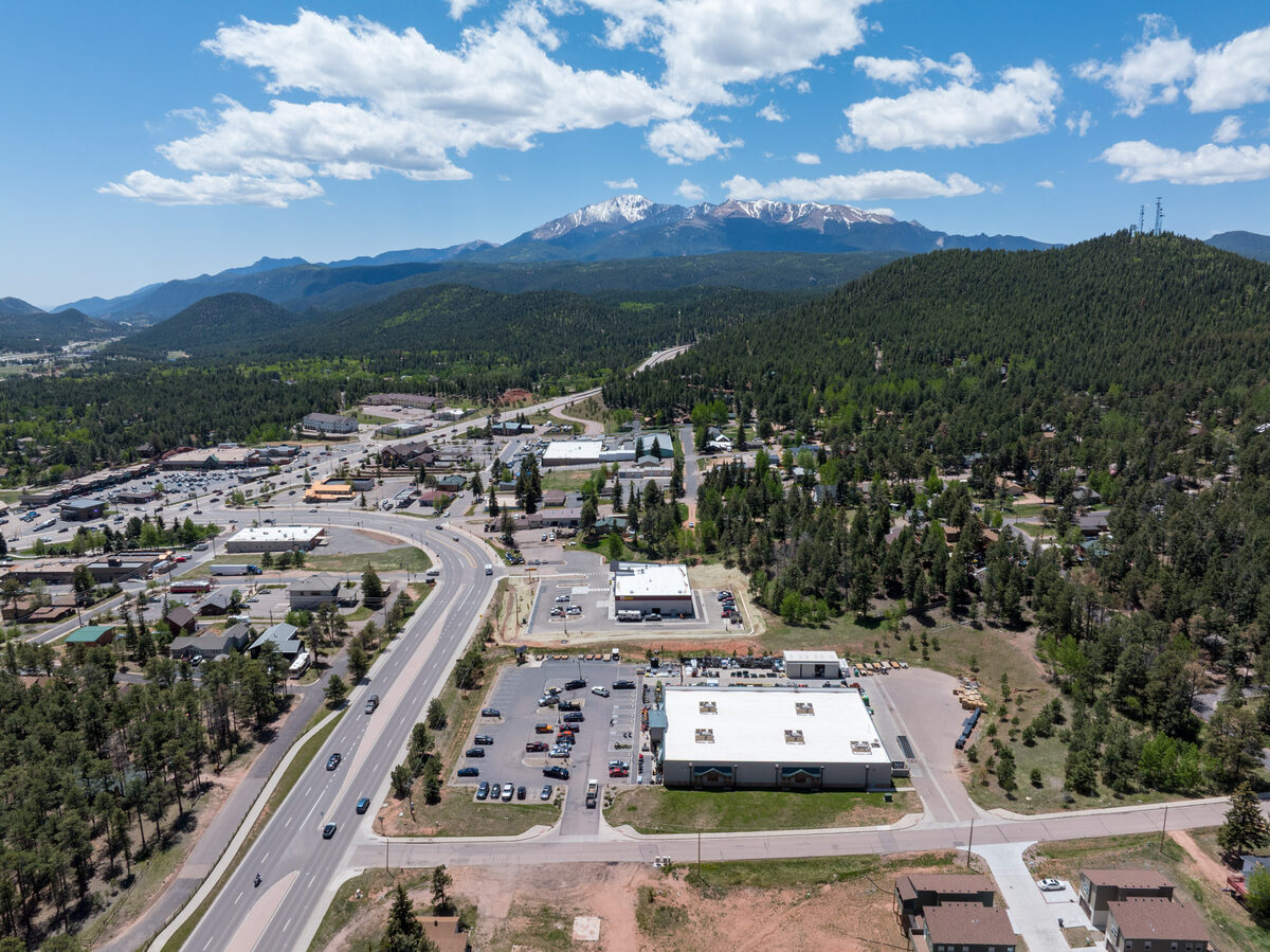 Aerial view of completed Les Schwab Tire Center in Woodland Park with Pikes Peak and Rampart Range in the background
