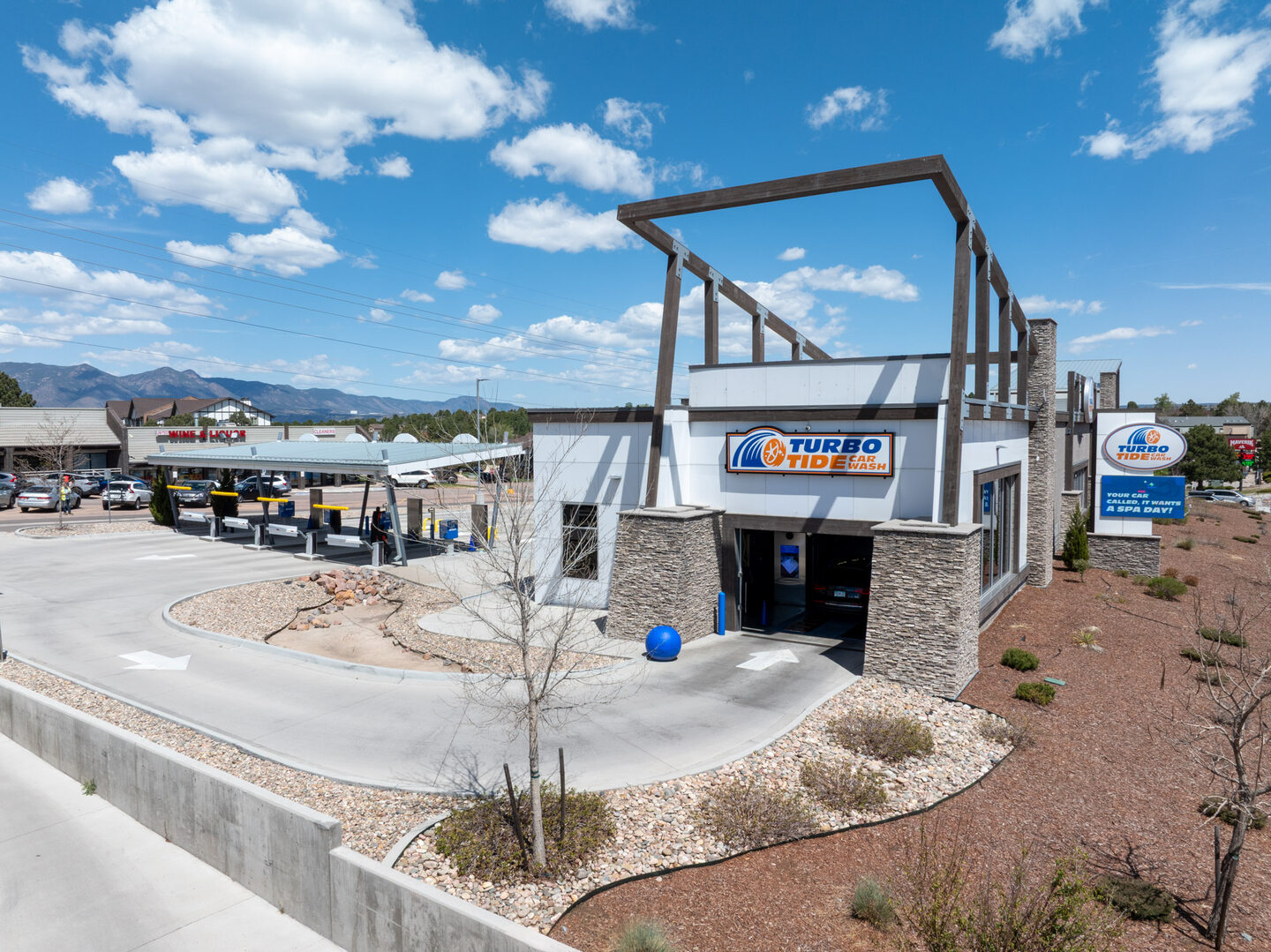 Low oblique aerial view of a commercial building under a dramatic Colorado cloud formation