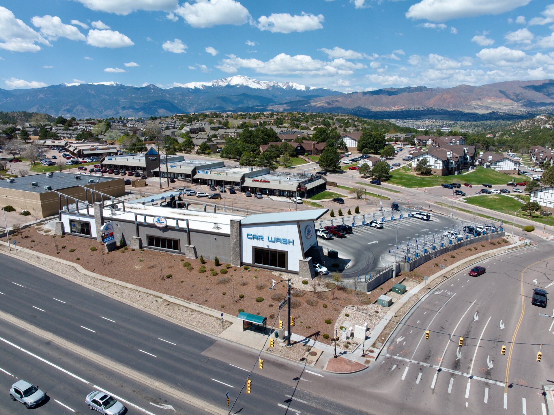 Aerial view of a commercial property with snow-capped Pikes Peak dominant in the background, Colorado Springs