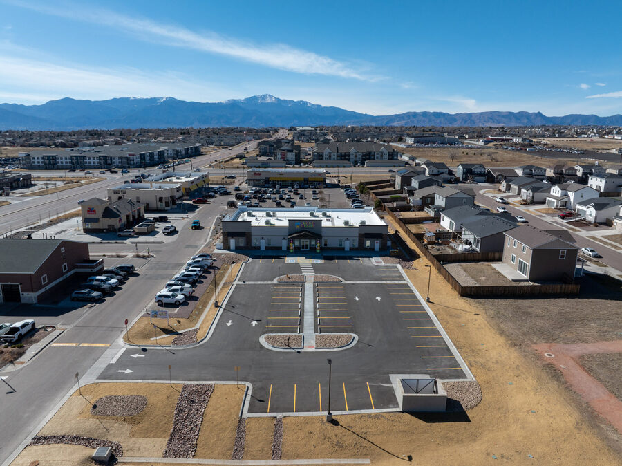 Aerial drone view of a completed commercial development with Pikes Peak and the Front Range in the background