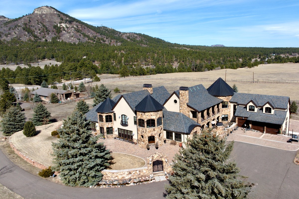 Aerial view of a luxury stone estate in the Colorado Springs foothills