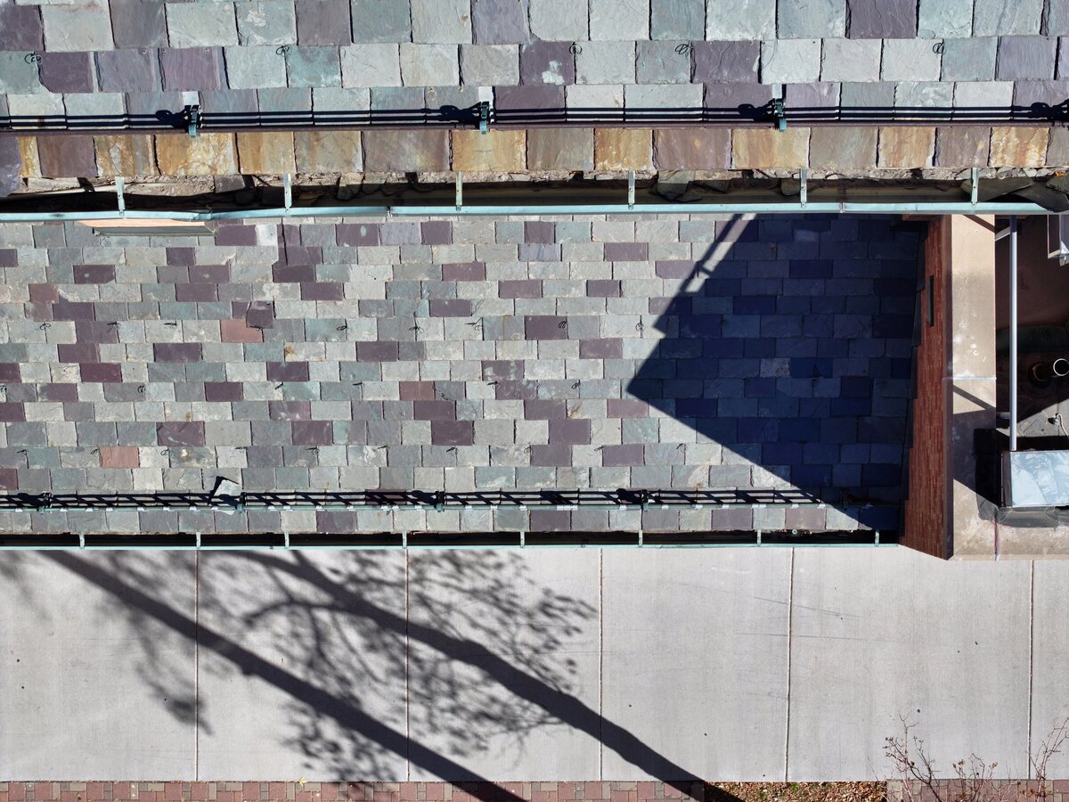 Eave and gutter close-up showing deteriorated tile edges and staining — the kind of detail that requires a drone to safely document