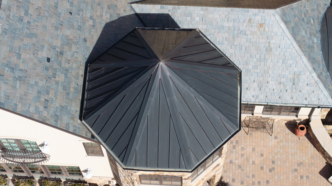 Overhead view of octagonal standing seam metal turret — every seam and the apex clearly readable, impossible to assess from the ground